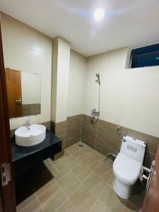 a bathroom with a toilet and a sink at CH Home in Danang +25 photos