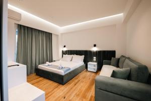 a hotel room with a bed and a couch at Hotel Zogaj in Ksamil