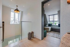 a hallway with a glass door leading to a living room at Westminster Apartments by D'Montrio in London +290 photos