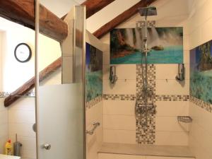 a shower stall in a bathroom with a painting on the wall at Landgasthof und Landhaus Hofmeister in Diemelsee +79 photos