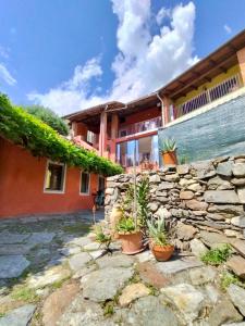 a stone wall in front of a house at Casa Luciana in Chiaverano