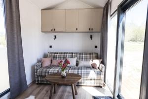 a living room with a couch and a table at ARIETES MARMONT Tiny Houses in Štrbské Pleso