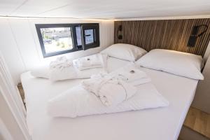 two beds in a room with white towels on them at ARIETES MARMONT Tiny Houses in Štrbské Pleso