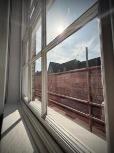a window in a room with a view of a train at Churchgate Apartment in Bury Saint Edmunds