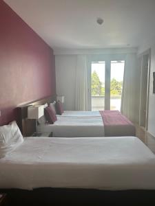 Postel nebo postele na pokoji v ubytování Hotel Coroa de Fátima