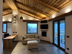 a living room with a couch and a table at Valtellina SkyLine EST in Villa di Tirano