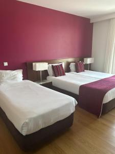 Postel nebo postele na pokoji v ubytování Hotel Coroa de Fátima