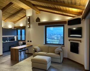 a living room with a couch and a table at Valtellina SkyLine EST in Villa di Tirano