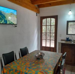 a dining room with a table with a bowl on it at ENRAMADA Hospedaje en San Marcos Sierras in San Marcos Sierras