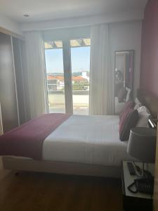 Postel nebo postele na pokoji v ubytování Hotel Coroa de Fátima