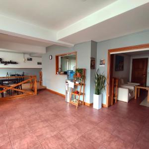 a living room with a table and a dining room at Hosteria Puyehue in San Carlos de Bariloche