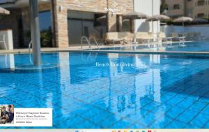 a swimming pool with blue water in a hotel at Rouge International Resort in Milano Marittima
