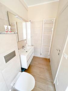 a bathroom with a white toilet and a sink at Don Pedro Beach House in Savona +22 photos