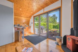 a kitchen with sliding glass doors leading to a patio at Brownthwaite Luxury Pod with Hot Tub at Fell View Park Kirkby Lonsdale in Casterton