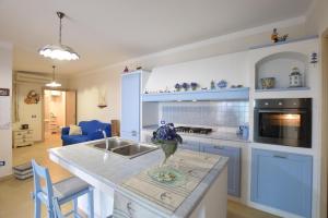 a kitchen with blue cabinets and a counter top at Mediterranean View in Marina di Ragusa