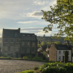 a large building in a town with a tree at The Hideaway - 2-Bedroom Apartment with outdoor terrace & free parking in Lancaster
