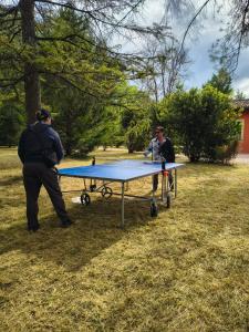 two men standing next to a ping pong table at Villa Pulcinella in Spoleto