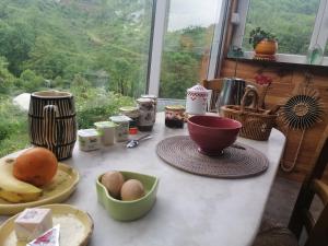 a kitchen counter with a table with eggs on it at La Succulente Vivace in Cambounès