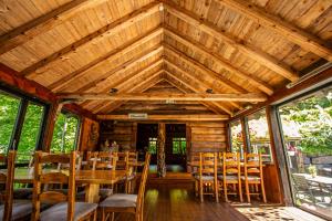 a wooden dining room with a table and chairs at Ullensvang Gjesteheim in Lofthus