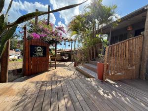 a wooden deck with a sign on a house at Sua Casa em Noronha - Conforto e Charme na Pousada da Iris in Fernando de Noronha