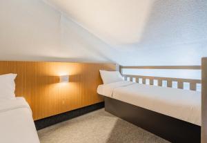 A bed or beds in a room at B&B HOTEL Strasbourg Sud Geispolsheim