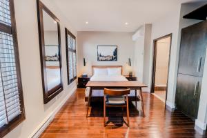 a bedroom with a bed and a table and chairs at Self Check-In Boutique Hotel - Quartier latin - Room 302 in Montreal