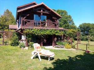 a house with a chair in the yard at Peaceful Retreat in Bessines-sur-Gartempe