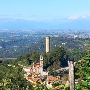 a building on top of a hill with a tower at Bella vista in Castellino Tanaro