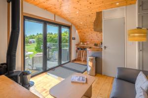 a living room with a couch and a table at Wandales Luxury Pod with Hot Tub at Fell View Park Kirkby Lonsdale in Casterton