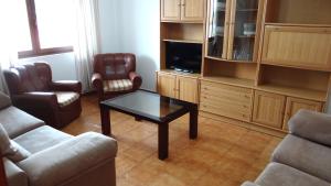 a living room with a couch and a coffee table at Casa Ardora - Playa de Carnota in San Mamede de Carnota