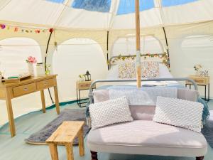 a bedroom with two beds in a tent at Luxury Stargazing Glamping - Seren Hardd with Hot Tub in Llanidloes