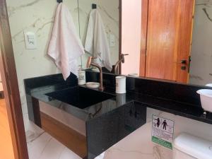 a bathroom with a sink and a mirror at Refúgio Três Estações in Paty do Alferes +49 photos