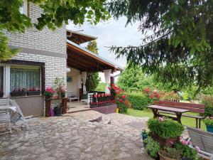 a patio of a house with a bench and flowers at Dečiji vinogradi Belgrade, Sopot, Kosmaj in Sopot