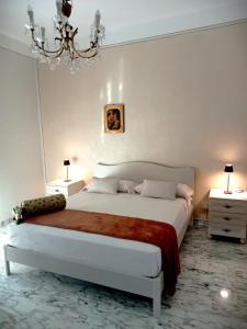 a bedroom with a large bed and two night stands at Miky M House in Venosa +24 photos