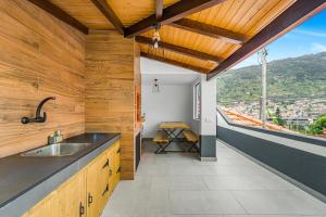 a kitchen with a sink and a view of a mountain at Casa da Guida in Machico