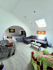 a large living room with a couch and a bed at Bulle Entre Parenthèses in Aroeira