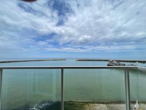 a view of a body of water from a balcony at Fenêtre sur Mer I CAP MER in Port-en-Bessin-Huppain