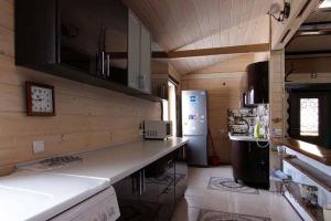 a kitchen with a counter and a refrigerator at Сім'я in Verkhovyna +24 photos