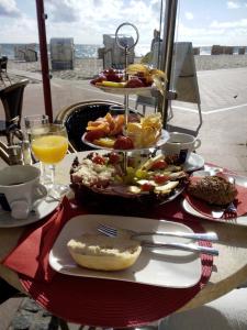 a table with two plates of food on a table at Apartment Ostsee Haus Sandra in Dahme