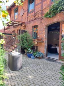 a brick building with a courtyard with potted plants at TheBackyard in Osterwieck