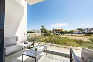 a living room with a couch and a table at Sunny Apartments in Cabanas de Tavira
