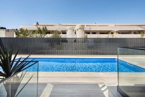 a swimming pool in a house with a fence at Sunny Apartments in Cabanas de Tavira