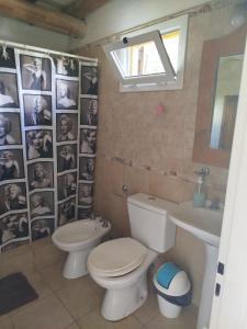 a bathroom with a toilet and a sink at Complejo de Cabañas Tierra de Luna in Potrerillos +82 photos