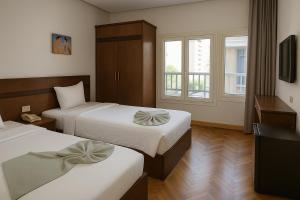 Postel nebo postele na pokoji v ubytování Miramar Evergreen Hotel + 27 fotografií