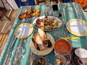 a table with plates of food on top of it at WILDSPIRIT Bedroom in Permaculture Paradise at WILDSPIRIT Eco Cultural Farm in Villanueva de Alcolea +34 photos