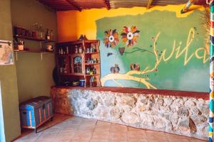 a room with a wall with flowers painted on it at WILDSPIRIT Bedroom in Permaculture Paradise at WILDSPIRIT Eco Cultural Farm in Villanueva de Alcolea