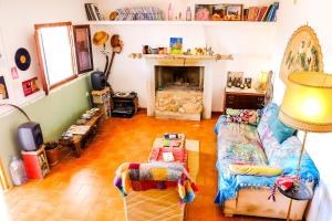a living room with a couch and a fireplace at WILDSPIRIT Bedroom in Permaculture Paradise at WILDSPIRIT Eco Cultural Farm in Villanueva de Alcolea
