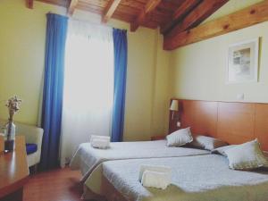 Cama o camas de una habitación en Hotel Ibaigune