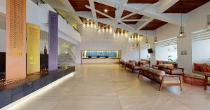 a lobby of a hotel with couches and chairs at Park Royal Beach Huatulco in Tangolunda