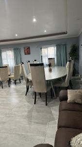 a dining room with a white table and chairs at Malaika Guest House in Cape Town